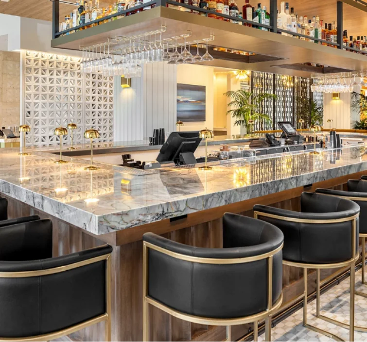 Elegant kitched with bar stools and marble counter.