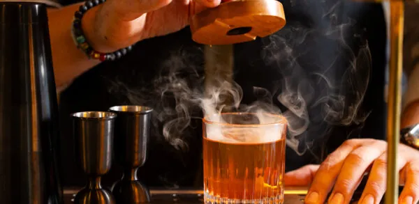 Bartender preparing cocktail.